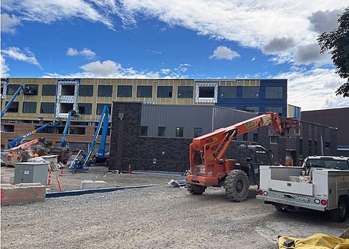 a four story building with lots of window openings is under construction